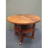 An Art Deco two-tier walnut occasional table, the circular top above smaller tier below raised on