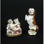 A porcelain and gilt metal mounted scent bottle/seal, modelled as a spaniel, raised on its hind legs