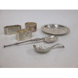 A small silver dish by Egan of Cork, 3 napkin rings, a caddy spoon and an anointing spoon,