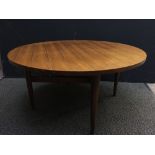 A Gordon Russell coffee table, the circular top raised on four tapering cylindrical legs united by
