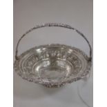 An Old Sheffield plate fruit basket with scroll decorated repaired (soldered) handle, 30.5cm