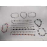 Thirteen contemporary bracelets, most stamped 925, all of similar design and differing finishes,