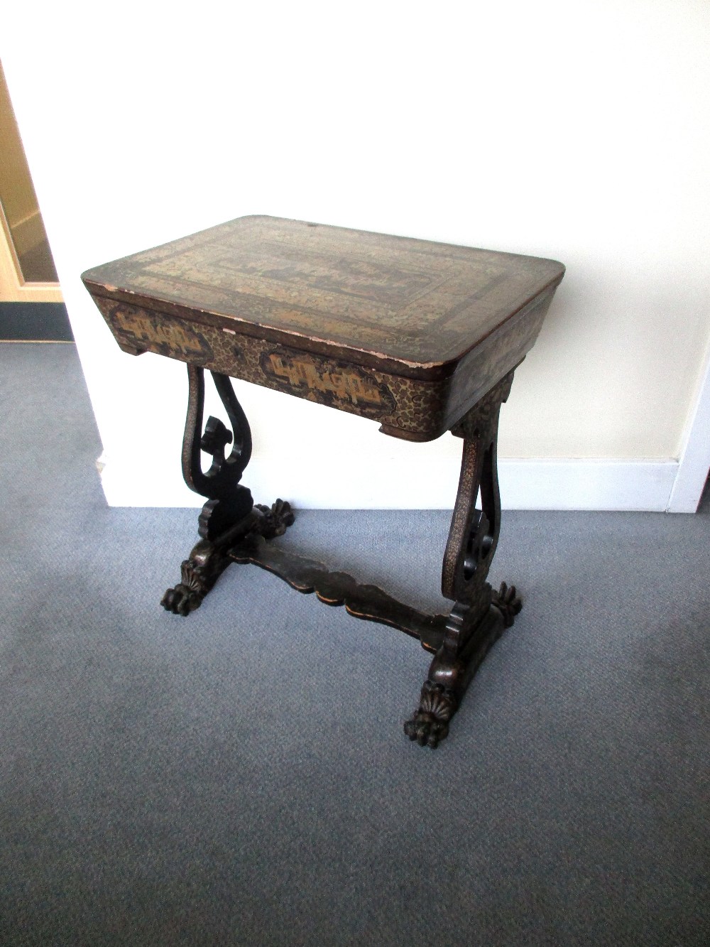 A mid 19th century Chinese black lacquer and gilt work table, with typical decoration, the hinged