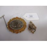 A 19th century memorial brooch, the oval brooch with central glazed and hairwork panel surrounded by