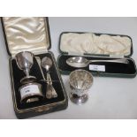 A silver egg cup, napkin ring and spoon, Birmingham 1938 & 1939, cased, and another silver egg spoon