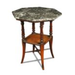 In the manner of E. W. Godwin, a marble topped centre table, the octagonal top on ring-turned