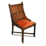 A Gothic oak hall chair, the panelled back with downswept supports to drop-in seat and raised on