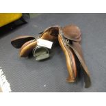 A 20th century leather saddle and a pair of Sheldon stirrups