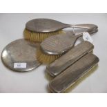 A five piece silver backed dressing table brush and mirror set