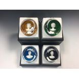 A set of four boxed Baccarat sulphide paperweights, the facetted weights each with portraits of