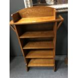 An oak open bookcase and a painted frame mirror