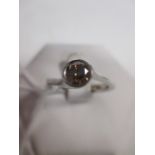 A fancy orange-brown diamond and platinum ring, the round brilliant cut diamond, estimated approx.