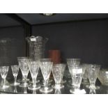 A collection of 1920's drinking glasses together with a set of three cased horn beakers with