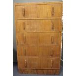 An Art Deco walnut chest of drawers, the rectangular top above five long drawers raised on a