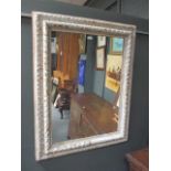 A rectangular silver painted mirror 80 x 58cm