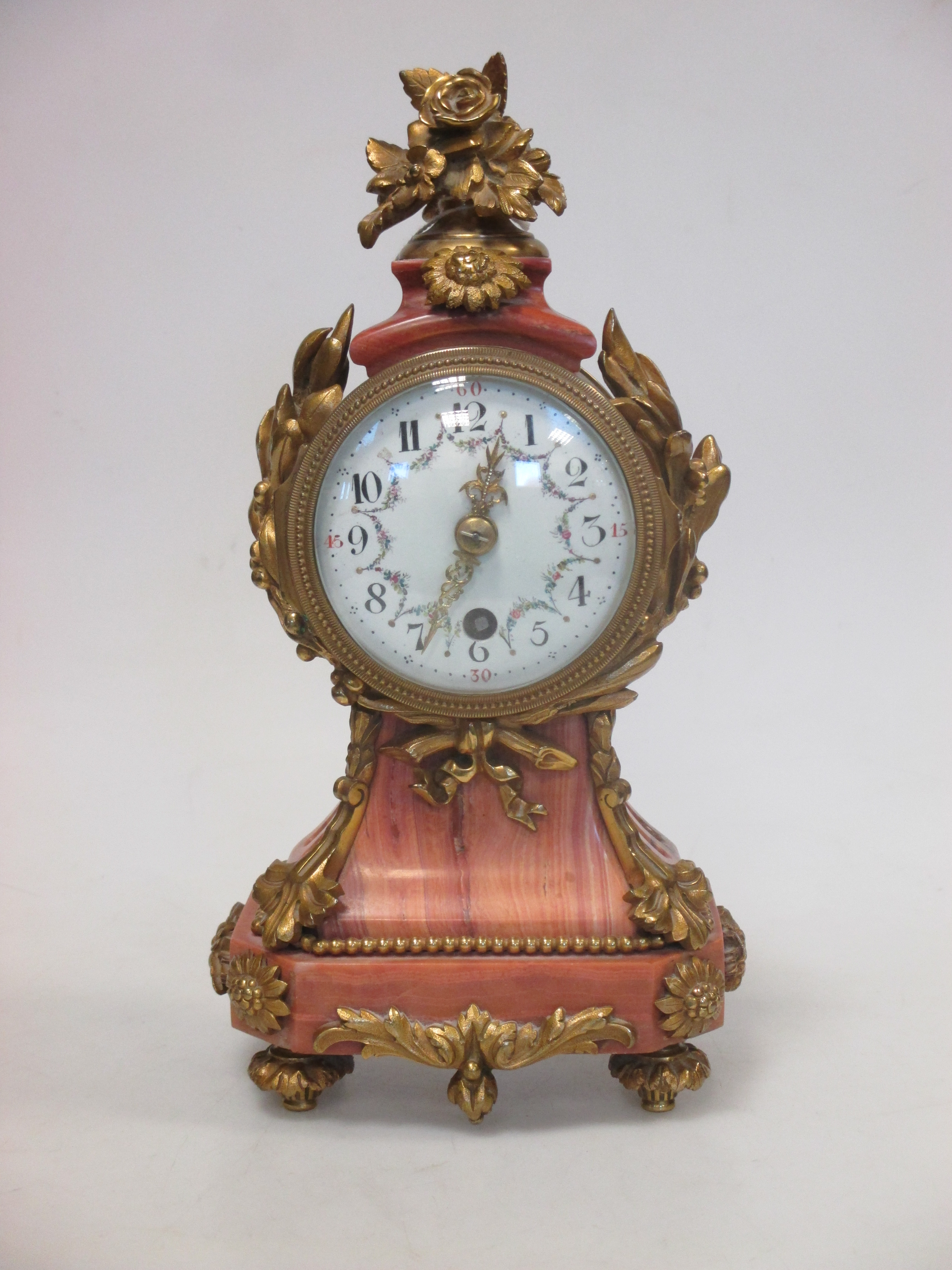 An ormolu mounted pink marble timepiece
