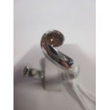 A fancy brown diamond and platinum ring, the round brilliant cut diamond, estimated approx. 0.57cts,