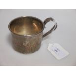 An American hammered silver beaker by Caldwell & Co, with loop handle