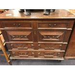 A late 17th century oak chest of drawers, with geometric drawer fronts on stile legs, 97cm h x 112cm