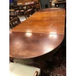 A Sheraton style mahogany D-end dining table with central drop leaf section on square tapered legs