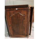 A George III oak hanging corner cupboard, 72cm wide