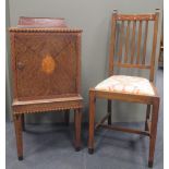 An early 20th century oak pot cupboard a pair of chairs en suite, inlaid with geometric banding with