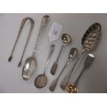 A George III dessert spoon, berry spoon, pair of mustards, sugar tongues and a sugar sifter
