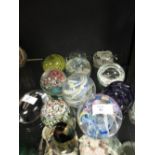 Twelve assorted glass paperweights, including Murano, Kosta Boda, Caithness etc.
