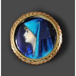 A Limoges enamel brooch, depicting a pre-raphaelite female portrait, signed to reverse 'Betourne,