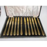 A cased silver manicure set and a cased set of 12 silver gilt tea knives (2)