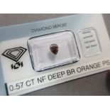A certificated 0.57ct pear cut natural fancy deep brown-orange diamond, the loose diamond in a