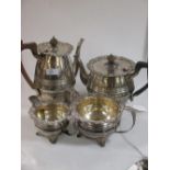 A matched four piece silver tea and coffee set with protruding rim having applied floral decoration,