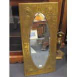 An Arts & Crafts brass framed mirror the rectangular frame