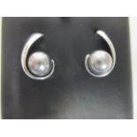A pair of cultured Tahitian pearl platinum earrings, the pearls, each approx. 8.1mm diameter, set in