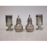 A pair of silver half fluted pepper casters by Henry Stratford Limited, Sheffield 1862 and another