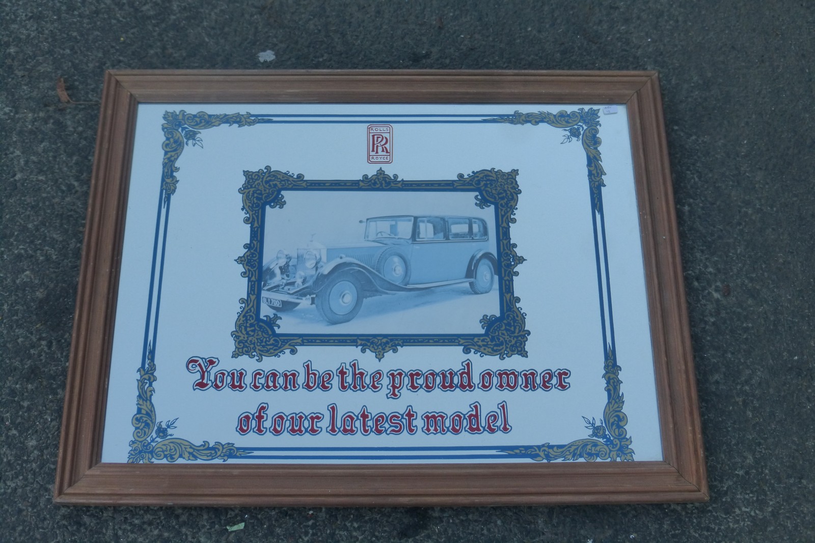 A decorative Rolls-Royce "You can be the proud owner of our latest model" advertising mirror, 26 3/4