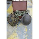 A WWII military helmet and a WWII style helmet plus a set of webbing including pouches.
