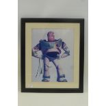 An autographed Toy Story photograph signed by Tim Allen.