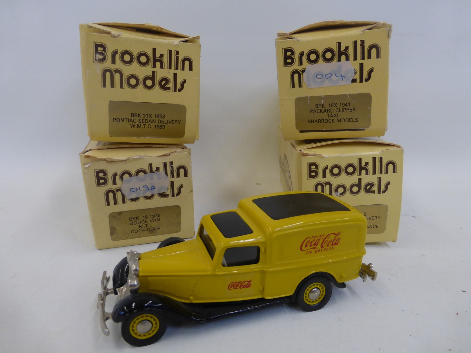 Four boxed Brooklin models - a 1936 Dodge Van M.T.I. Coca-Cola, a 1941 Packard Clipper Taxi