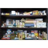 Three shelves of pharmaceutical products, packaging etc, for display purposes.