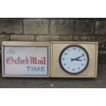 A rectangular two section wall clock/light box "It's Oxford Mail Time" with a Smiths bakelite