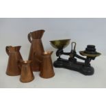 A set of four graduated copper jugs, the tallest approximately 11 1/2 inches, and a set of kitchen