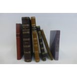 An assortment of volumes including "The History and Antiquities of Tewkesbury Abbey and its