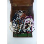 A jewellery box with assorted contents.