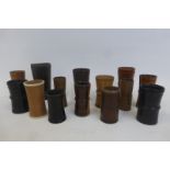 A collection of treen and leather dice shakers of various ages and styles.