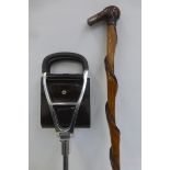 A folding shooting stick seat and an unusual walking stick with a silver tip to the handle.