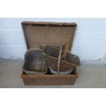 A wicker picnic basket and three assorted shopping baskets.