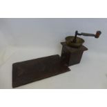 A 19th Century coffee grinder with attached tray of unusual form (possibly elm).