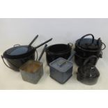 An assortment of black enamel kitchenalia including a kettle and saucepans etc.