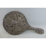 A silver backed hand held mirror.